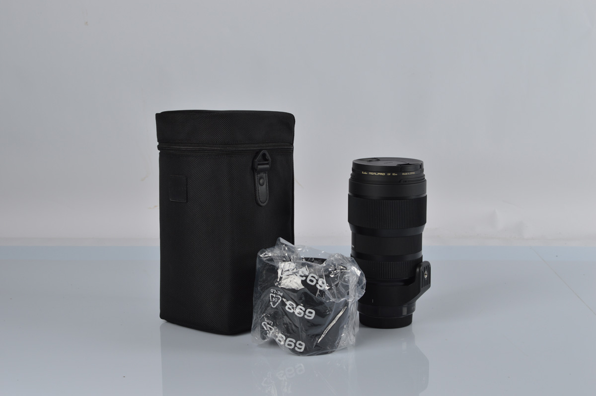 A Sigma for Canon 50-100mm 1:1.8 DC telephoto lens, in soft carry case.