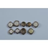 A collection of seven silver and white metal trench watch faces, together with two cases (9)