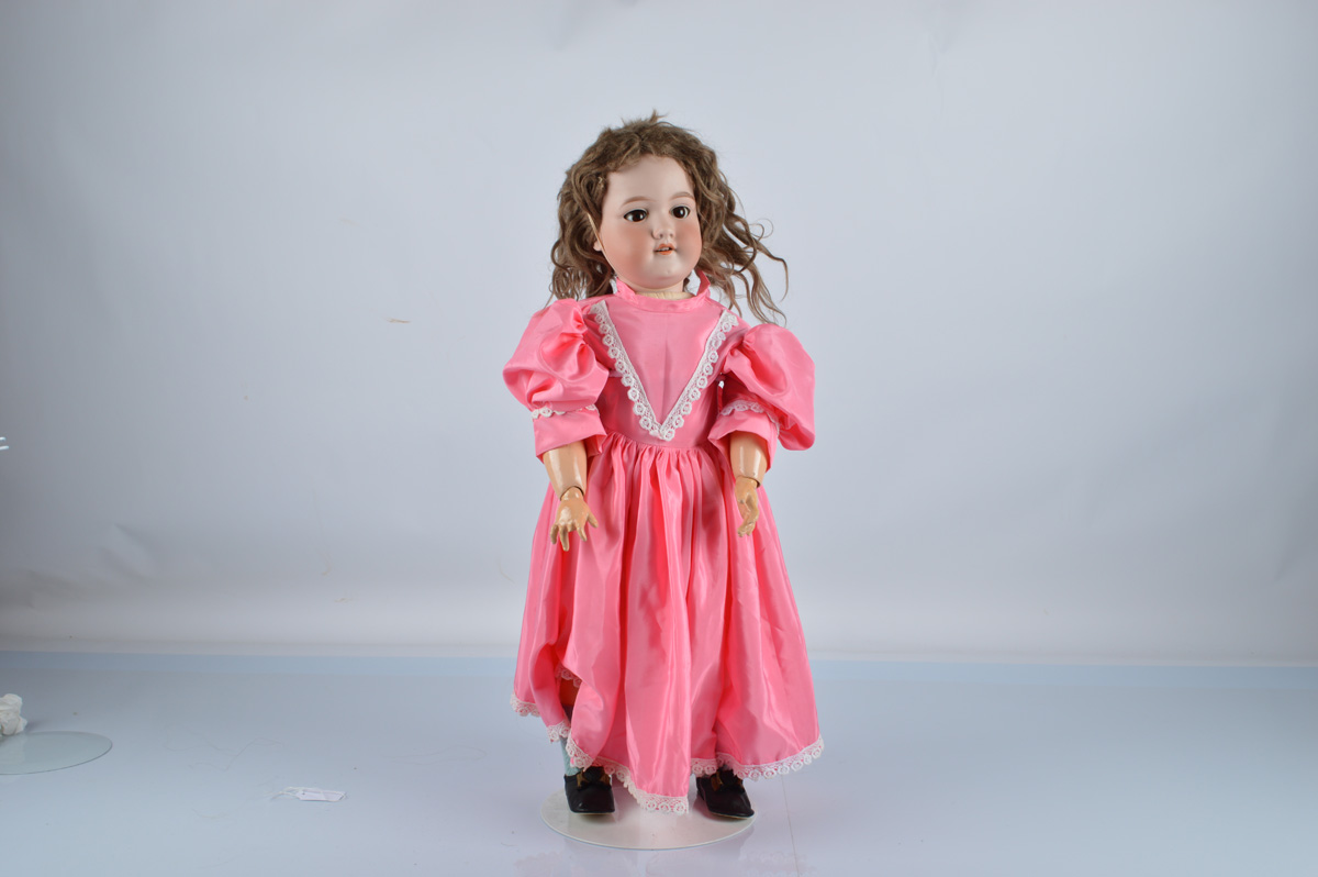 An Armand Marseille 390 child doll, with brown sleeping eyes, brown mohair wig, jointed