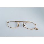 A pair of yellow metal framed spectacles, (missing glass lenses) 5.6g