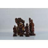 Five Chinese hardwood carved figures, including Chinese Immortals and a Dragon figure, 32cm tall.