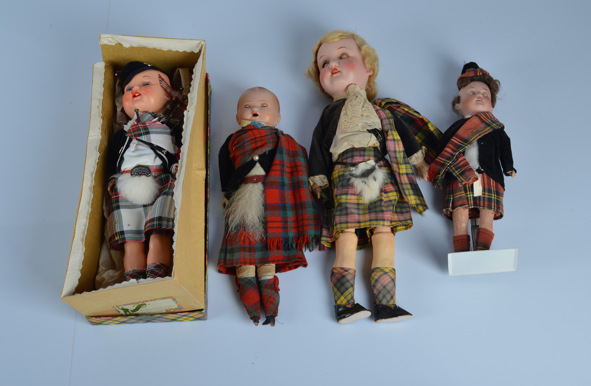 Four Scotsman dolls in original costumes, the smallest an AM 390 with bisque head, 10 inch (25.