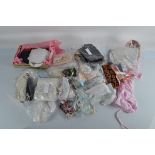 A quantity of dolls dresses and accessories, including a pair of boots, small hand fans, various