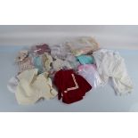 Two boxes of vintage dolls clothes, various sizes including orange and pink Victorian style dress,