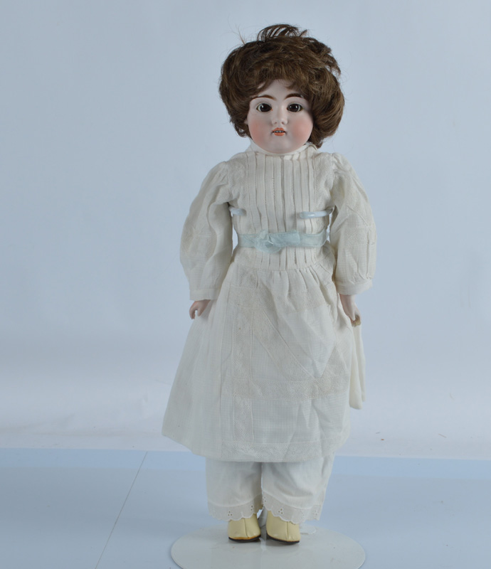 A Kestner shoulder head doll, with brown eyes, open mouth, four teeth, on a kid leather body with