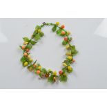 A vintage continental glass tutti frutti necklace, with stylised lemons, pears, oranges and other