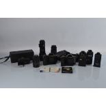 A collection of assorted cameras, lenses and accessories, including two Canon T90 camera bodies, a