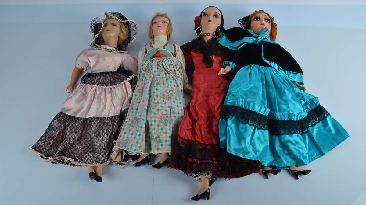 Four continental composition headed boudoir dolls, with stuffed elongated bodies with composition