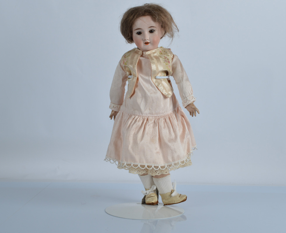 A Recknagel 1914 child doll, with brown sleeping eyes, brown mohair wig, jointed composition body