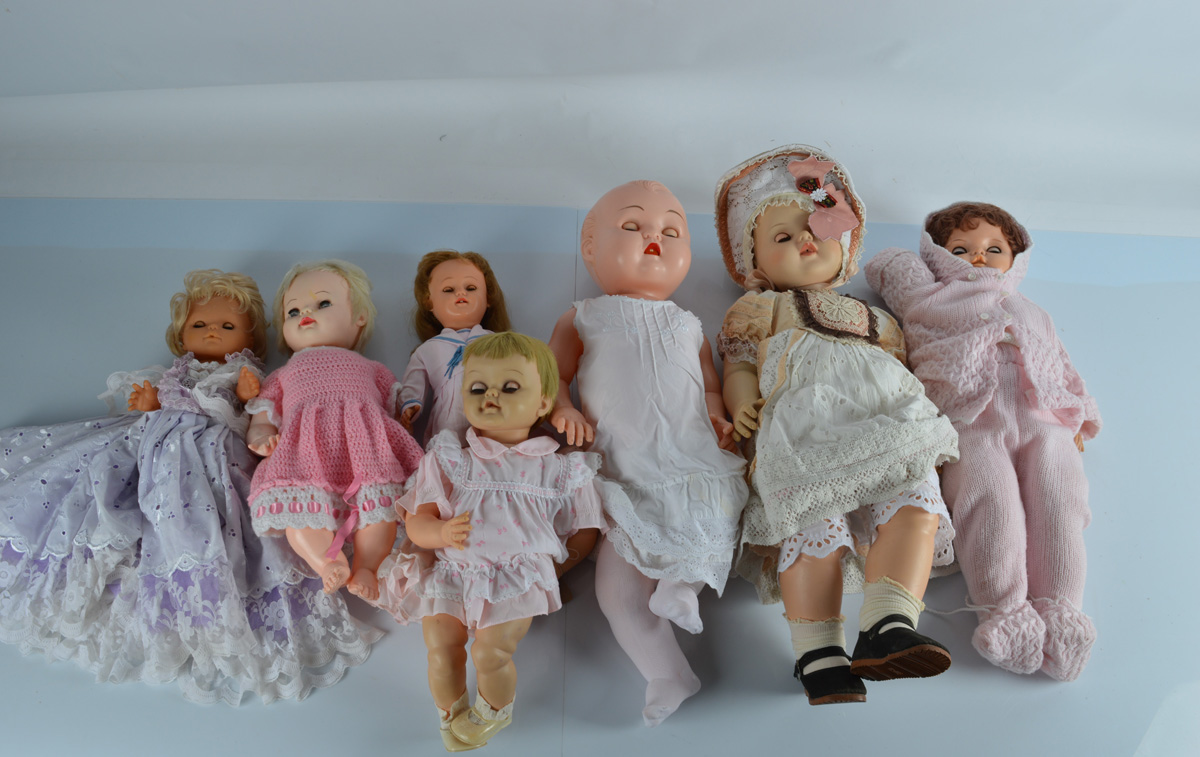 A quantity of vinyl and plastic baby and child dolls, in various knitted and contemporary costume