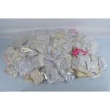 A quantity of doll dresses, including various underskirts, dresses etc mostly white and cream