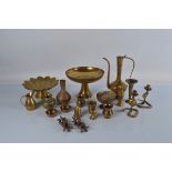 A mixed lot of assorted brassware, mostly embossed Indian examples including cups, flasks, vases,