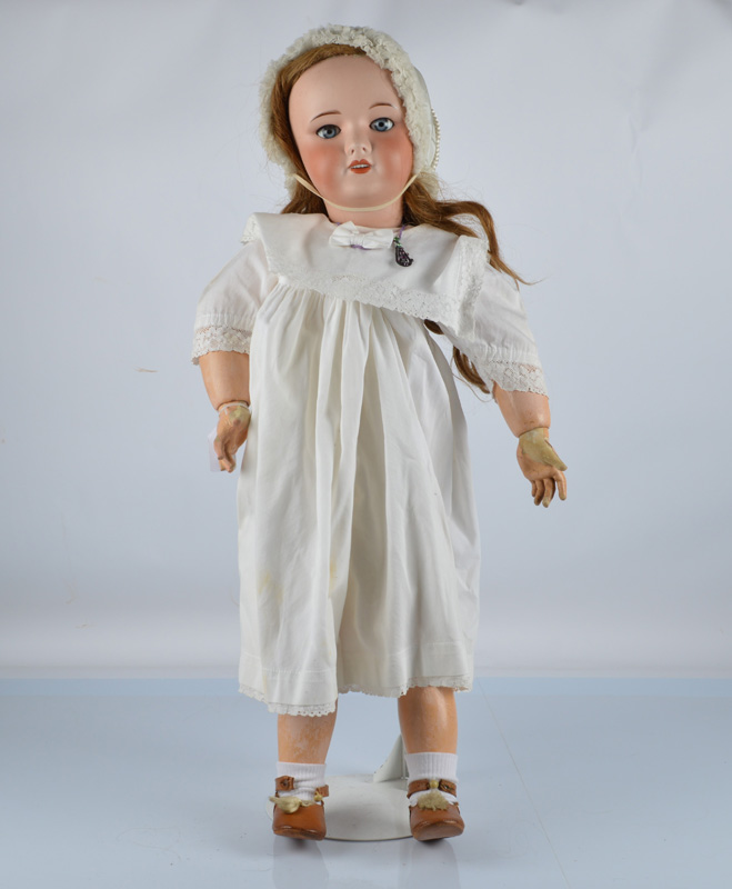 A large Unis 301 (SFBJ) child doll, with blue sleeping eyes, long hair wig, jointed papier mache and