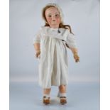A large Unis 301 (SFBJ) child doll, with blue sleeping eyes, long hair wig, jointed papier mache and