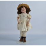 A SFBJ 60 child doll, with fixed blue eyes, replaced brown wig, jointed papier mache body, yellow