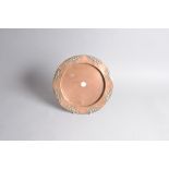 An Arts & Crafts copper charger by J.S. & S, 31cm diameter, some bending and damaged