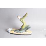 An Art Deco style spelter figure, modelled as a young lady in green dress, hands loose and head