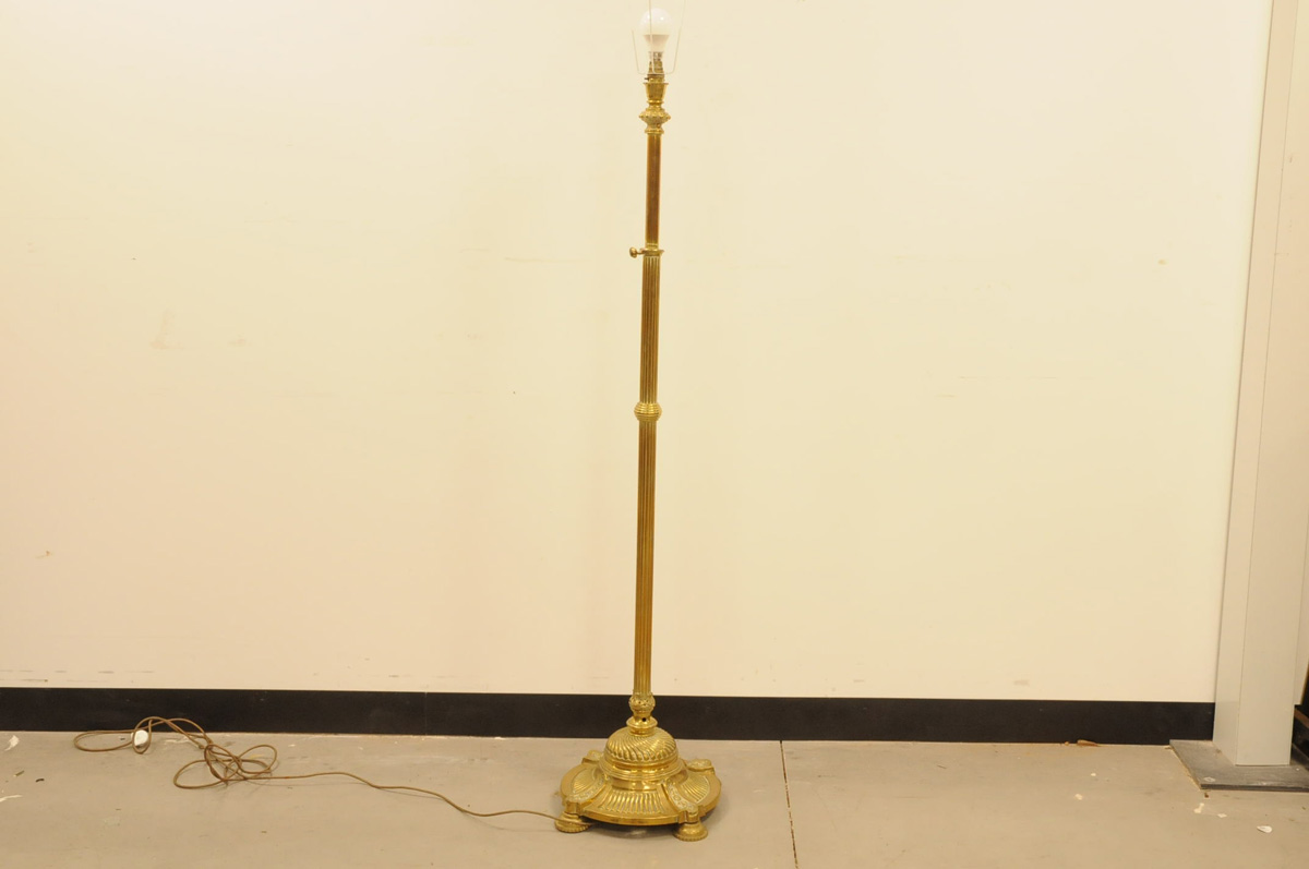 A Victorian brass standard lamp, 140cm to light fitting, with cast iron in base, appears to adjust