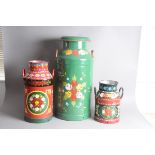 Three modern barge ware churns, the largest a milk churn and lid green painted with floral design by