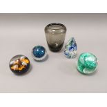 A group of four 20th Century glass paperweights, together with a smoky glass vase, height 13cm (5)