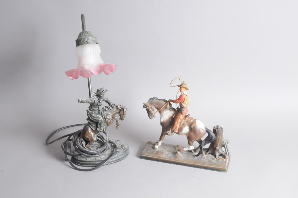 Two vintage cowboy related decorative items, including a cowboy on horseback matchstrike, 26cm,