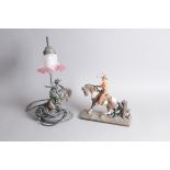 Two vintage cowboy related decorative items, including a cowboy on horseback matchstrike, 26cm,