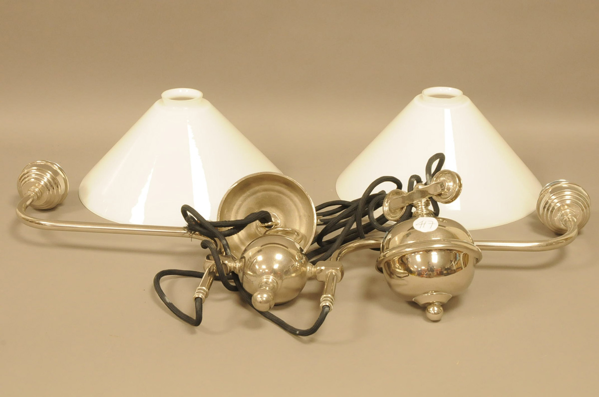 A modern chromed rising ceiling light, twin branch with opaque white conical shades