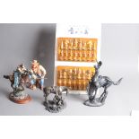 Four modern Cowboy related figures, together with a Cowboys & Indians chess set