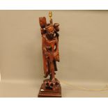 A mid 20th century Chinese wooden carved figural lamp base, 84cm high, the figure of a man, probably