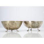 A pair of Cypriot white metal bowls, marked 800, having three vignettes on three feet supports, 24.