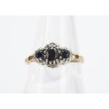 A three stone sapphire and diamond dress ring, in white and yellow gold setting and shank, ring size