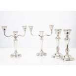 Two pairs of Art Deco silver filled candle holders, one pair with twin branches and three sconces,