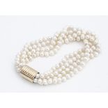 A contemporary four strand freshwater knotted pearl choker, on a cylindrical barrel clasp, 38cm long