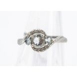 A 9ct gold aquamarine and diamond three stone crossover dress ring, ring size K, 1.8g