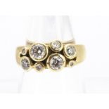 An 18ct gold diamond dress ring, in a modern cluster setting by Helen Brice, the brilliant cuts in