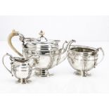 An Edwardian silver three piece tea set by James Dixon & Sons, oval footed forms with raised