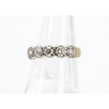 A diamond half hoop eternity ring, the brilliant cuts in white metal on a yellow gold hallmarked