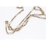 A 9ct gold full guard chain, the triple knotted links alternately set with elongated oval batons,