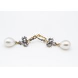 A pair of pearl and diamond drop earrings in 14gt gold,