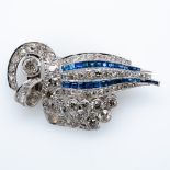 An Art Deco sapphire and diamond clip brooch, the old cuts in collet and claw settings with two