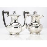 A 1950s silver hot water jug and a 1960s silver coffee pot by EV, of traditional form with applied