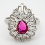 A ruby and diamond 14ct gold dress ring, in a ballerina style setting, the central mixed cut pear