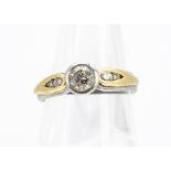 A diamond solitaire dress ring, in platinum with gold set diamond shoulders, ring size J, 4.9g