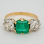 A three stone emerald and diamond Antique ring in 18ct gold,