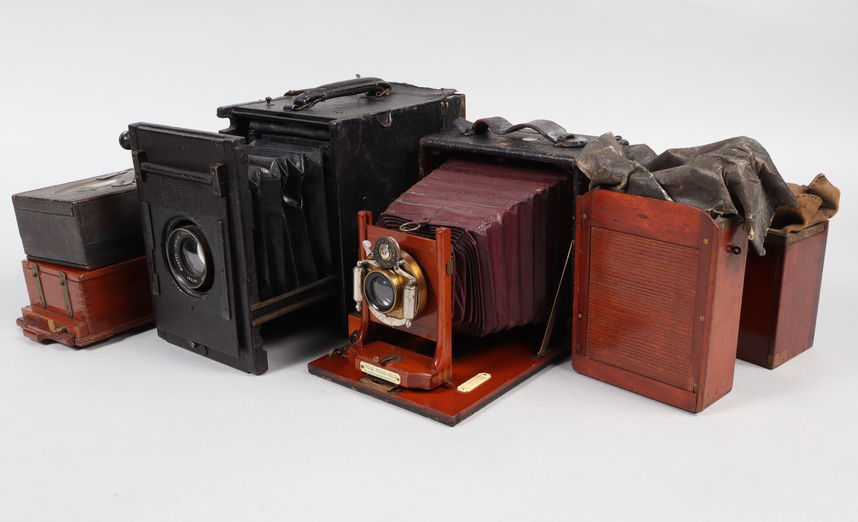 An Adams Minex and Other Cameras, an ICA Bebe strut-folding camera with film pack holder, an Adams
