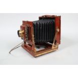 A Houghtons Ensign 'The Victo' Half-Plate Mahogany Field Camera, circa 1905, triple extension, black