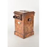 A mid-19th Century burr walnut-veneered Table Double-Stereoscope, with oval label 'Adjusting