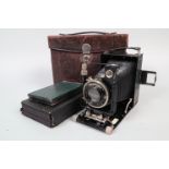 A Voigtländer Bergheil 9 x 12cm Folding Plate Camera, circa 1934, the green leather has turned