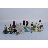A collection of assorted empty perfume and scent bottles, including iridescent art glass examples,