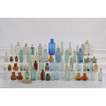 A large collection of bottles, including Bovril, seven blue bottles, and various other miniature